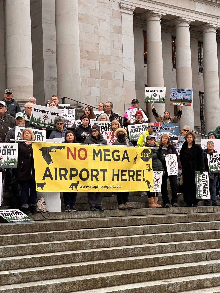 Protestors hold a sign that reads "No Mega Airport Here," at the state capitol on January 25. (Credit: Lauren Gallup / NWPB)