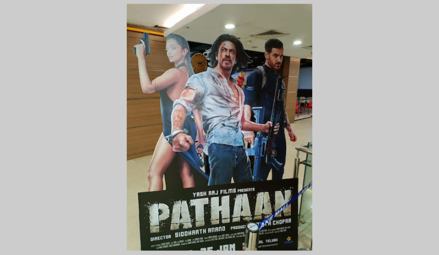Cutouts of Pathaan characters at a movie theatre in Kolkata.