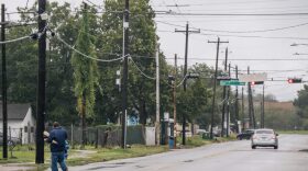 A person walks through a neighborhood in the Fifth Ward after Tropical Storm Nicholas moved through the area in Houston, Texas.  (Photo by )