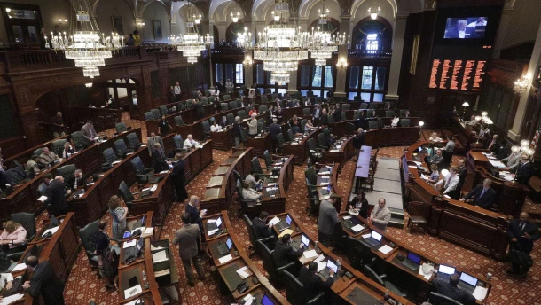 Illinois lawmakers listen to debate on the House floor during a session at the Illinois State Capitol.