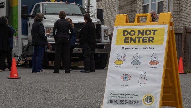 South Carolina Department of Public Health staff stand in front of an agency Mobile Health Unit in Spartanburg.
