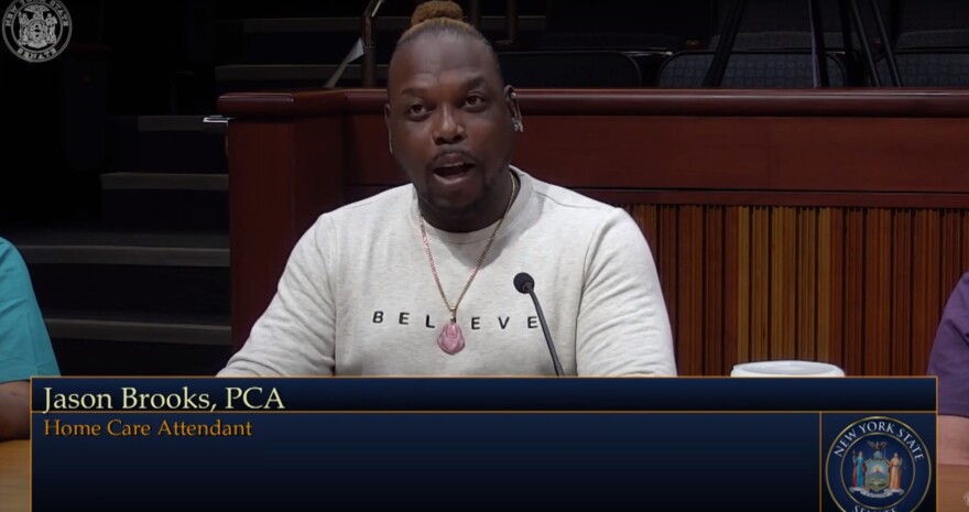 Jason Brooks, a home care aide in Rochester, testifies before the New York State Senate during a joint public hearing July 27, 2021.