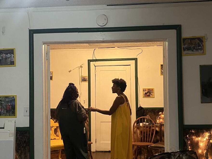 Courtney Rohan, 47, sings in a yellow dress in a blue house in West Charlotte as part of the play “Dauntless: An Ode to 2916."