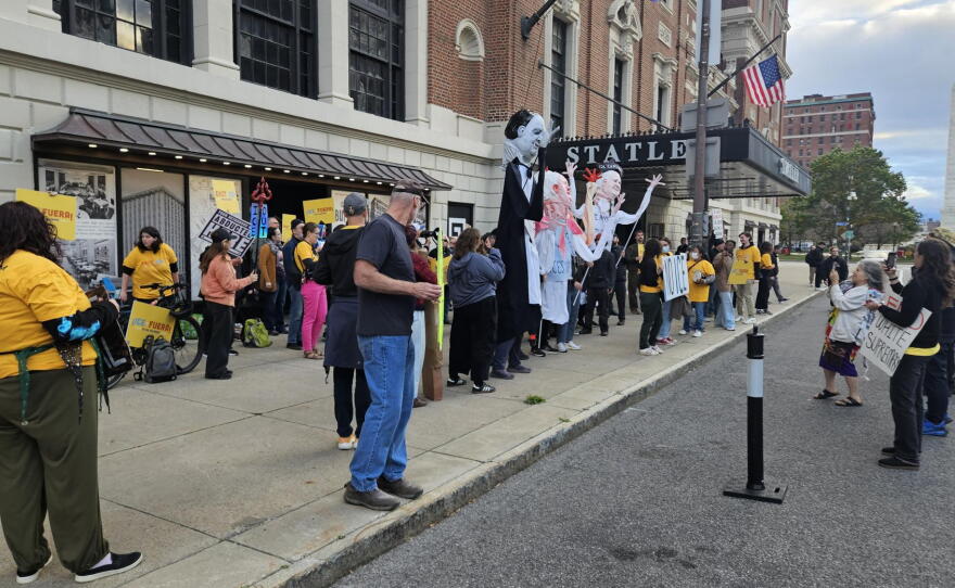 Protesters stand outside the Statler Building, calling for Carl Montante to end rental agreements with ICE
