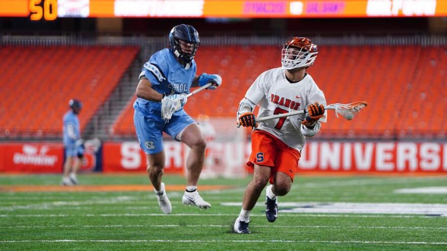 SU middie Michael Leo (7, white) battles in the loss to the Tar Heels back in February, two months before he would score the game-winner against UNC.