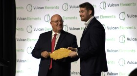 Vulcan Elements CEO John Maslin accepts a gold-plated tobacco leaf from Butch Lawler, chairman of the Johnston County Board of Commissioners. Vulcan announced Tuesday that it plan to build the world's largest magnet factory outside of China in Benson, with the $918 million facility slated to support about 1,000 new jobs.