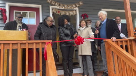 Alonda Emery. The woman on her right is the department of housing commissioner Seila Mosquera-Bruno. Beside him is the Neighborhood Housing Services Executive Director Jim Paley.