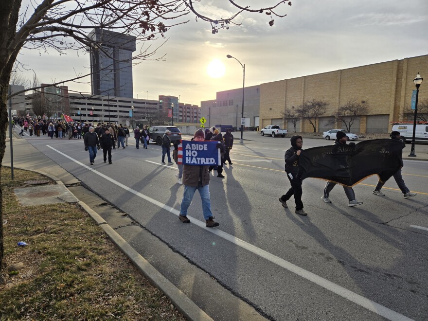 Marchers in Monday's MLK Day parade, including members of Alpha Phi Alpha with their banner.