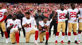 K'Waun Williams, Arik Armstead and Eli Harold of the San Francisco 49ers kneel while holding their hands over their chest during the U.S. national anthem before playing against the Washington Redskins at FedExField on Oct. 15, 2017, in Landover, Md. (Patrick Smith/Getty Images)