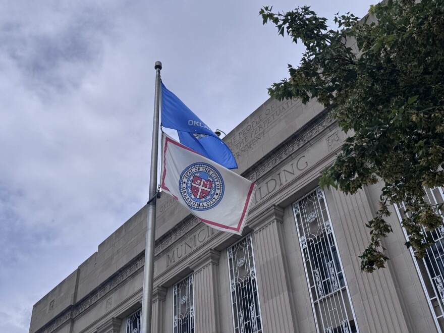 The Oklahoma City flag flies beneath the state flag at a municipal building on July 16, 2026.