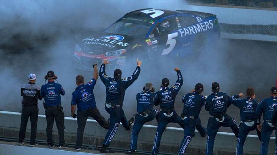 Members of Kasey Kahne's pit crew celebrate as Kahne performs a burnout following his win in the Brickyard 400 Sunday, July 23 at the Indianapolis Motor Speedway.