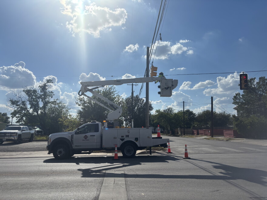 A San Antonio Public Works crew repairs a traffic signal Saturday following severe storms that caused widespread power outages and damage across the city.