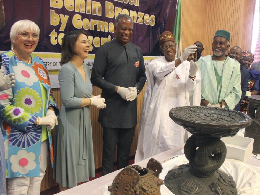 Germany's Foreign Minister Annalena Baerbock (second from left) and Nigeria's Minister of Information and Culture Alhaji Lai Mohammed (fourth from left) are pictured during the ceremony. Germany has returned 22 historic bronze sculptures to Nigeria as part of efforts to address what its foreign minister called its "dark colonial past."