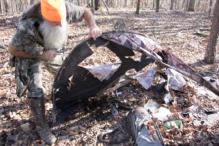 Charles Benton examines the destroyed campsite he says he ran from after seeing Bigfoot. 