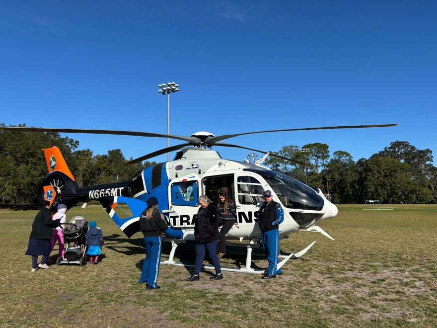 Participants can be seen exploring the cockpit of the helicopter.