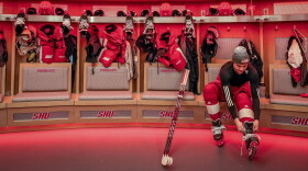 Men's forward Kevin Lombardi laces his skates in the locker room of the newly constructed NCAA college hockey Martire Family Arena on the campus of Sacred Heart University in Fairfield, Conn., Monday, Jan 9, 2023.