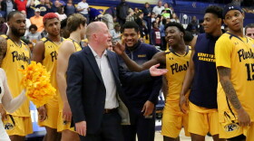 Kent State Men's Basketball coach Rob Senderoff is congratulated by team members earlier this season.