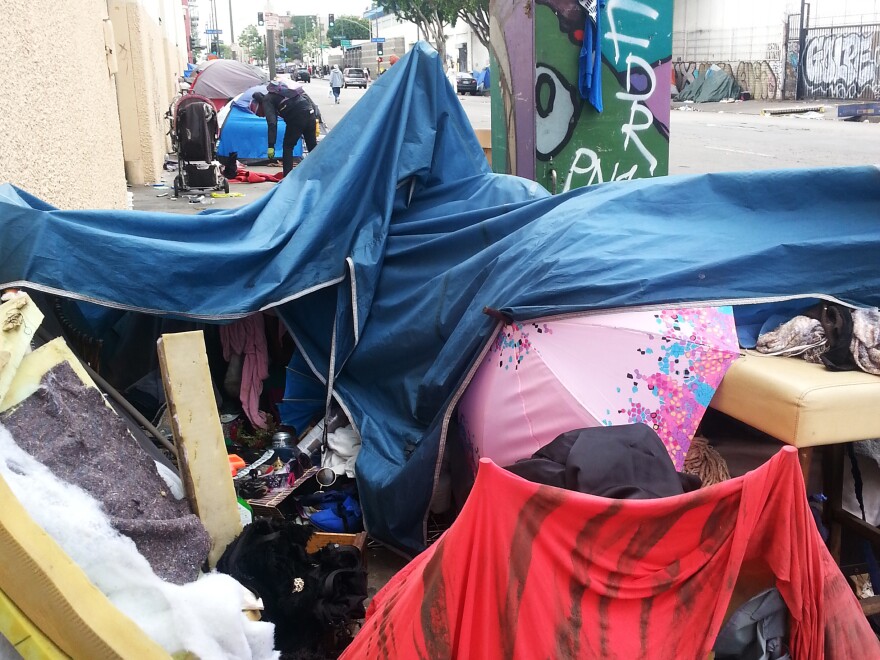 A pink umbrella peeks through a collapsed tent home on L.A's Skid Row.