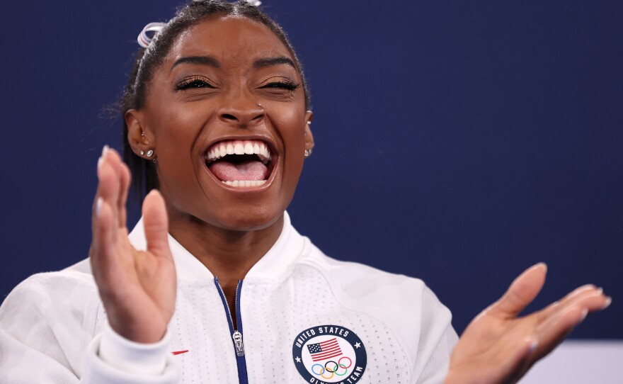 Simone Biles cheers during the Women's Team Final on Sunday at the Tokyo 2020 Olympic Games.
