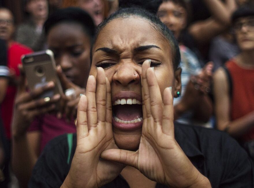 A protestor shouts slogans as they march from Manhattan to Brooklyn in New York, Friday, July 8, 2016. Demonstrators took to the New York City streets chanted "hands up, don't shoot" and "no justice no peace." to protest the recent police shootings in Louisiana and Minnesota, just one day after five police officers were killed and seven others wounded during a protest in Dallas. (AP Photo/Andres Kudacki)