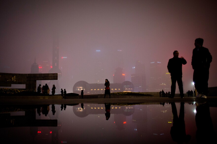 People walk on the Bund, the riverfront area next to the financial district in Shanghai. Many foreigners have descended on Shanghai to make money on China's economic expansion. NPR's Frank Langfitt met one such woman as part of the free taxi rides he's been offering.