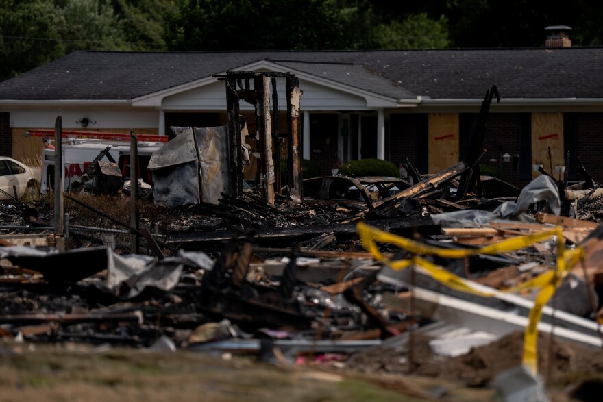Debris and wrecked cars cover the site where homes once stood after a house explosion damaged about 20 residences on Monday, Aug. 25, 2025, near Black Jack.