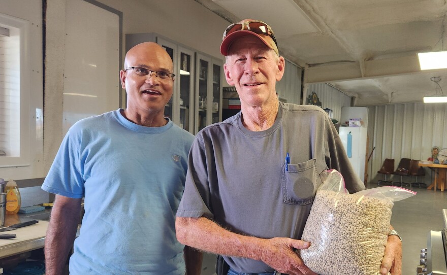 Srinivasa Pinnamaneni, Ph.D from Colorado State University joins Delta farmer Mike Ahlberg as he shows off first commercially grown black eyed peas on the Western Slope