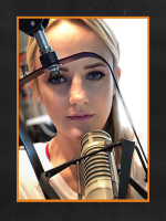 Photo of Bentley behind a radio microphone with an orange border around the photo over a black-ish background