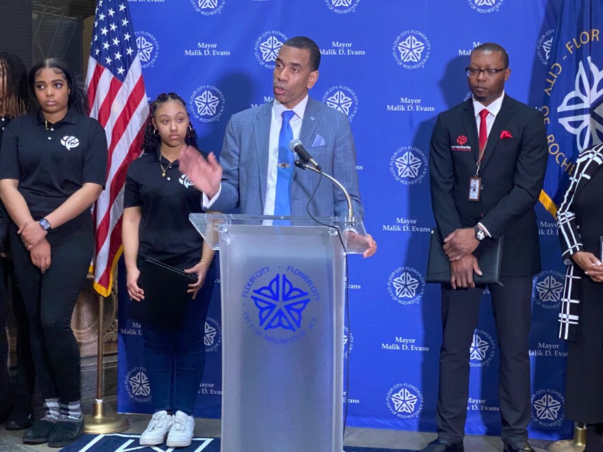 Mayor Malik Evans stands among members of Youth Voice One Vision in City Hall's Atrium