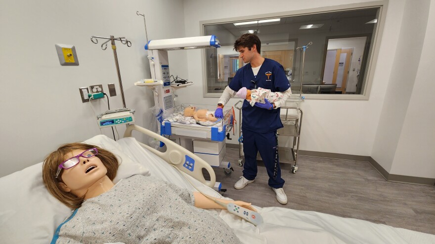 Penn State Scranton nursing student John Evans shows one of the new patient simulator rooms in the school's renovated nursing suite.