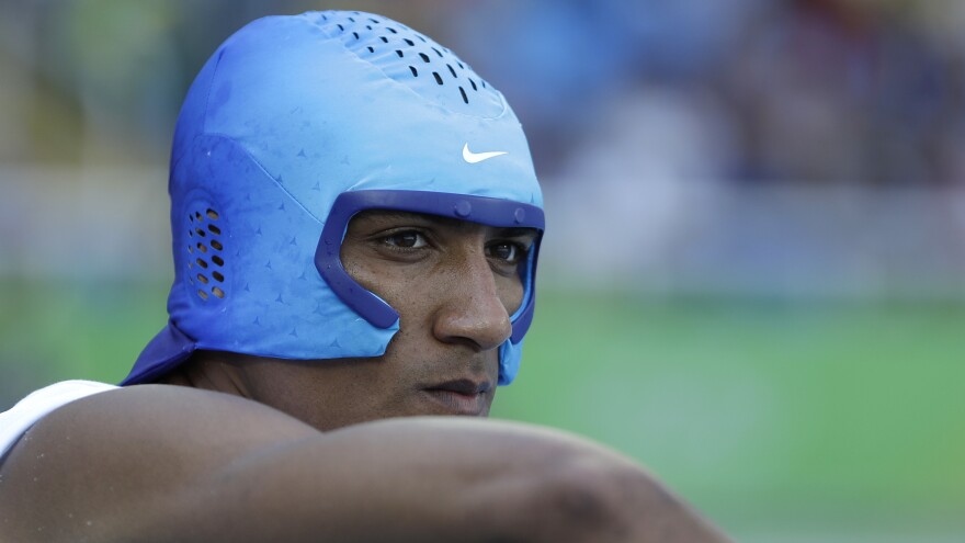 Eaton wears a cooling cap during the decathlon competition on Wednesday. The decathletes were on the track from early in the morning until late in the evening both Wednesday and Thursday.