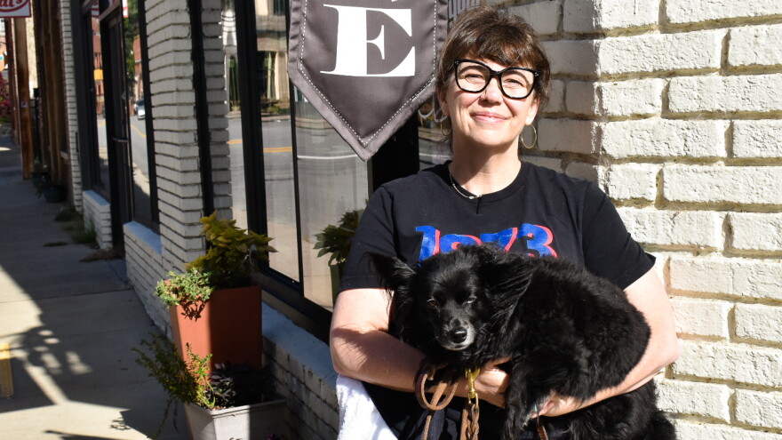 Alex Webber and her dog in front of On Your Bike Cafe in Marshall.