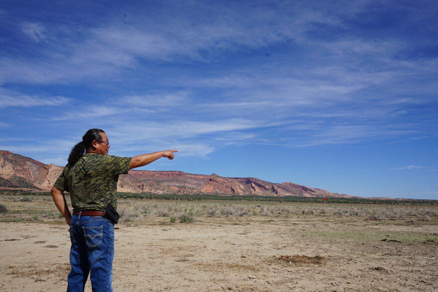 Peaches points towards land his cattle graze on near Black Mesa.