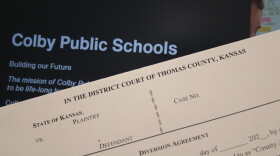 A blank diversion agreement sits in front of a computer with the Colby Public School's website. 
