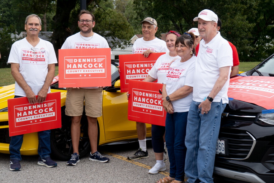 St. Louis County executive candidate Dennis Hancock, right, stands with supporters during the St. Ann Day parade on Sept. 27 in St. Ann. Most paradegoers lining Ashby Road responded to Hancock's campaign appeals with little more than a handshake and a hello.