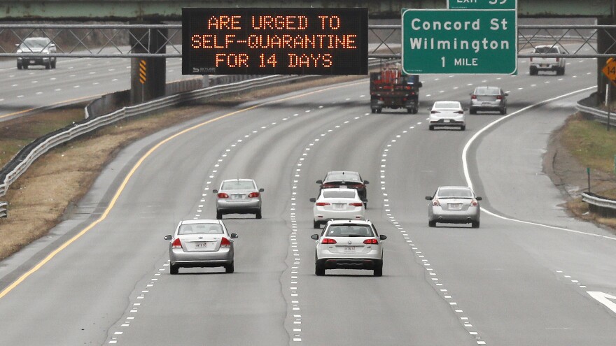 A highway sign urges out-of-state visitors to self-quarantine for 14 days if they plan on staying in Massachusetts.