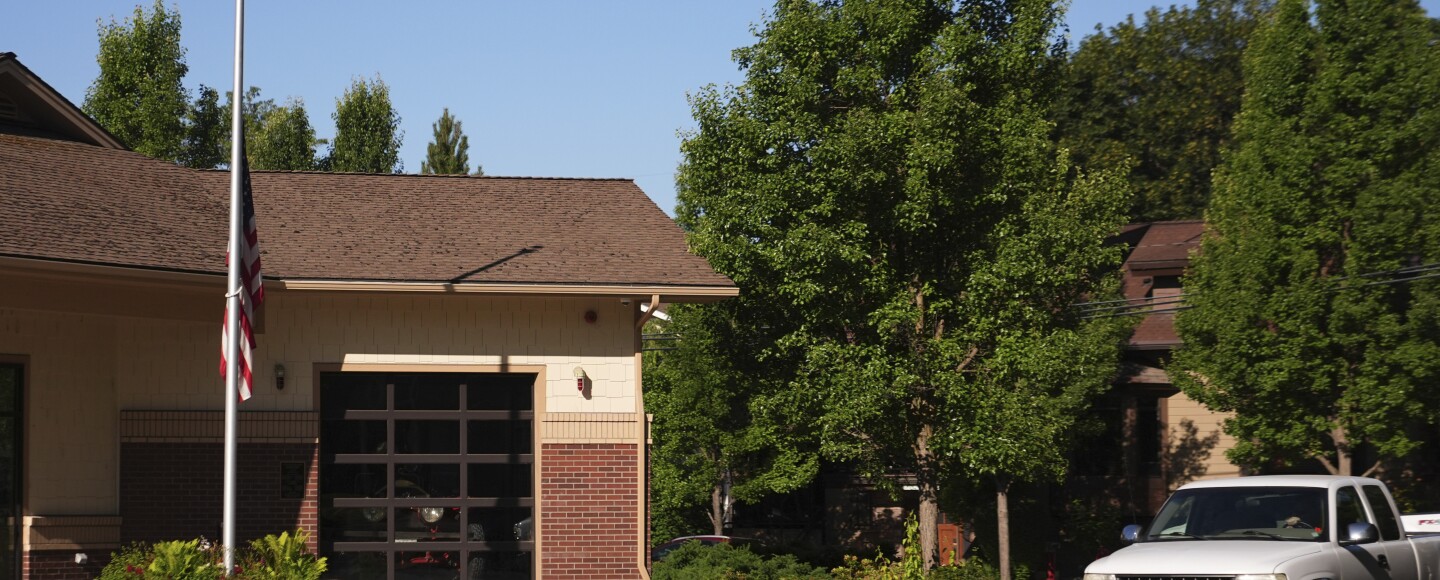 An American flag flies at half-staff outside the Coeur d'Alene Fire Department the day after a shooter ambushed and killed multiple firefighters responding to a wildfire at Canfield Mountain Monday, June 30, 2025, in Coeur d'Alene, Idaho.