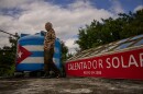Felix Jose Morfi stands by his solar-powered water heater system he set up on his home's roof in Regla, Havana province, Cuba, Thursday. Jan. 29, 2026.
