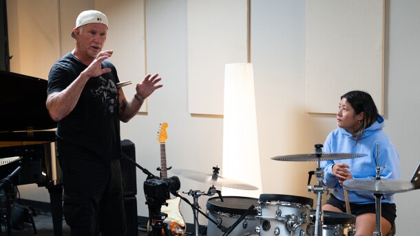 Red Hot Chili Peppers drummer Chad Smith with a student musician.