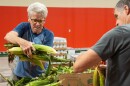 Steve Vossler, left, volunteers at the Harvester's distribution center in Lawrence, Kansas.