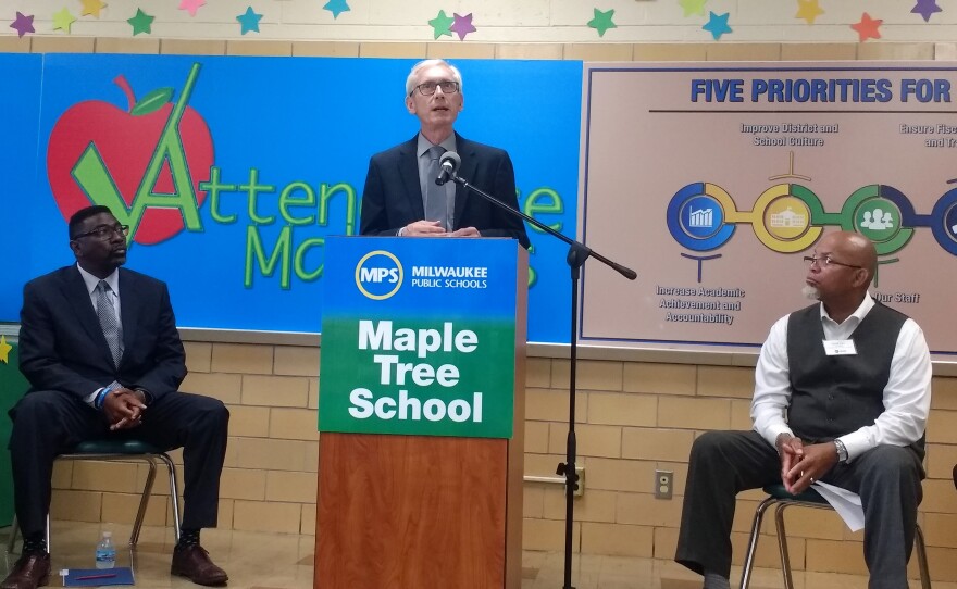 state_superintendent_tony_evers_speaks_at_maple_tree_school_as_mps_interim_superintendent_keith_posley_and_school_board_president_mark_sain_look_on.jpg
