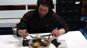 a musher eats a meal inside