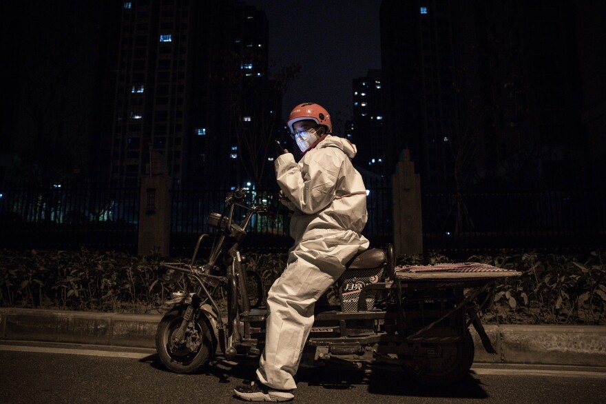 A courier in protective gear on his motorcycle.