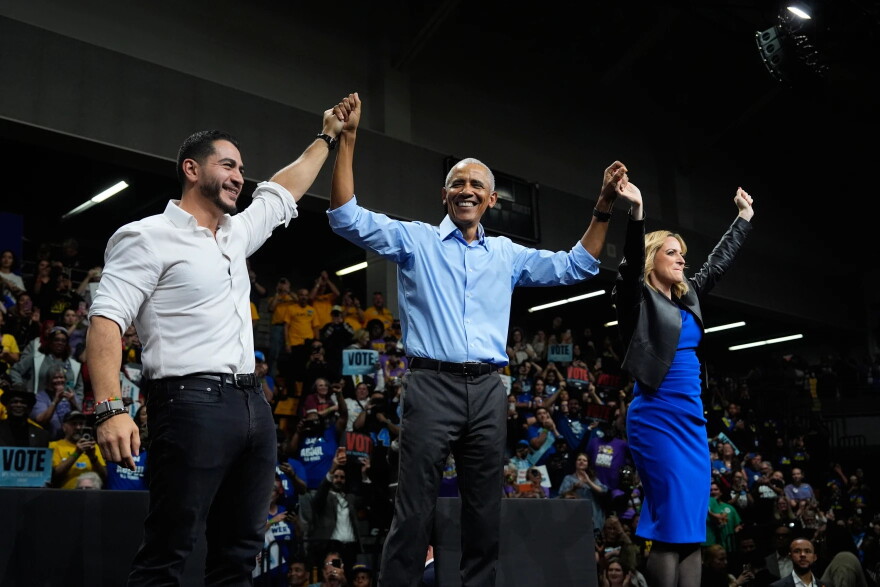 Former President Barack Obama, center, joined by Democratic nominee for U.S. Senate Abdul El-Sayed, left, and Democratic gubernatorial nominee and Michigan Secretary of State Jocelyn Benson raise hands during a campaign event at Cass Technical High School Saturday, Oct. 24, 2026, in Detroit.