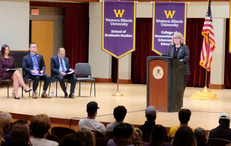 WIU President Kristi Mindrup addresses the crowd at the University Assembly. She was joined on stage by (from left to right) Ketra Roselieb, Vice President for Finance and Administration; Justin Schuch, Vice President for Student Success; and Mark Mossman, Provost and Academic Vice President.