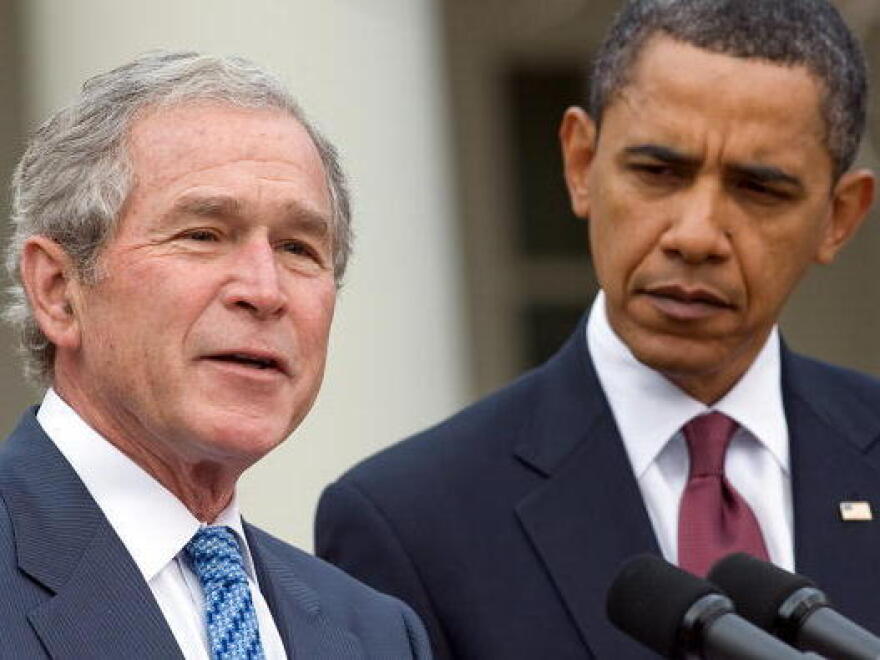 Former President George W. Bush, standing with President Obama, speaks about relief efforts in Haiti in January 2010.