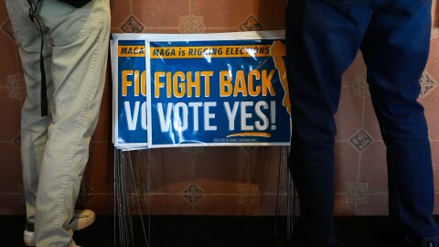 Signs in support of the Virginia redistricting referendum are seen as Jen Strozier and Doug Mock, members of the Goochland Democratic Committee, order lunch at GG's Pizza, Thursday, April 2, 2026, in Maiden, Va.