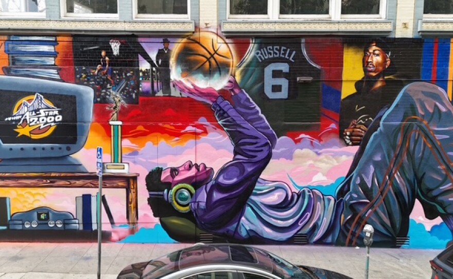 Muralist Timothy B with his work "Hoop Dreams"