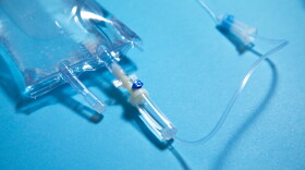 This stock photo shows an IV bag on a blue background.