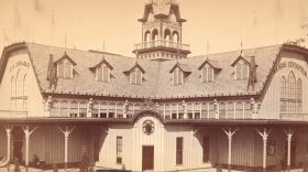 A black and white photo of a large wooden building.